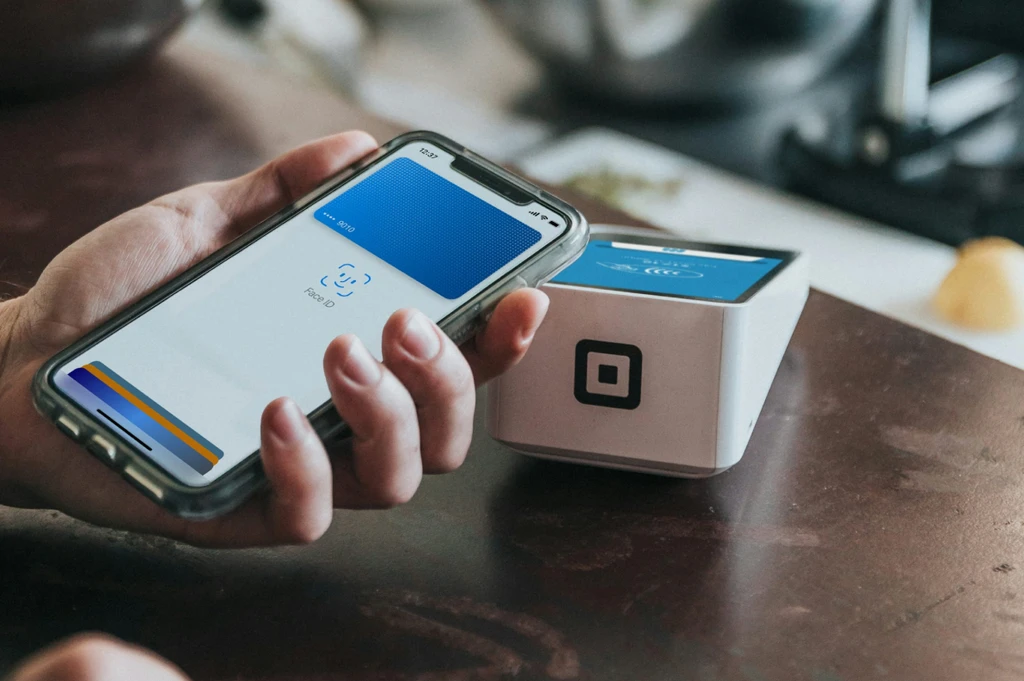 Customer paying by phone at a card reader
